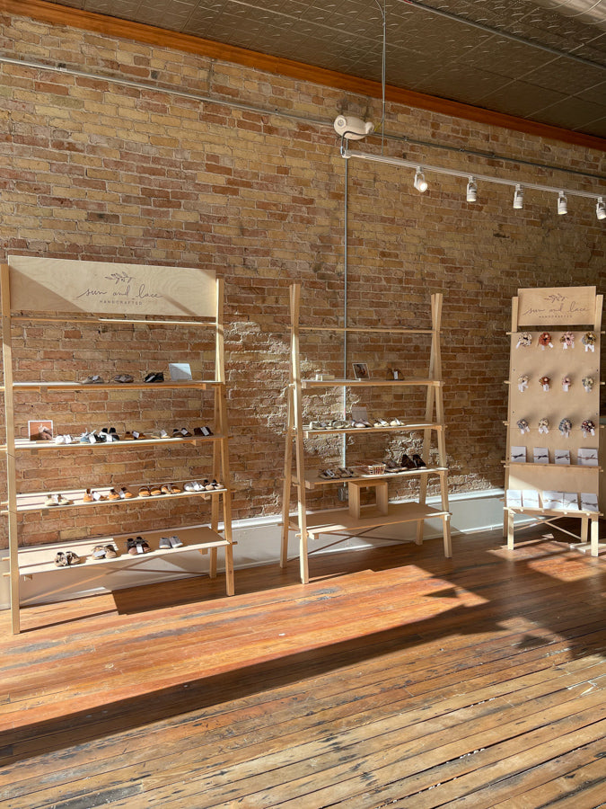 Caraclarkdesign shop in-person Stoughton WI. Exposed brick walls with original wood floors.