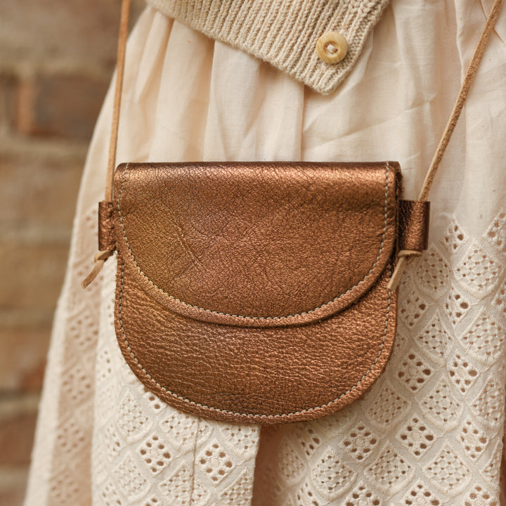Toddle leather purse in bronze paired with toddler girl holiday outfit on mannequin